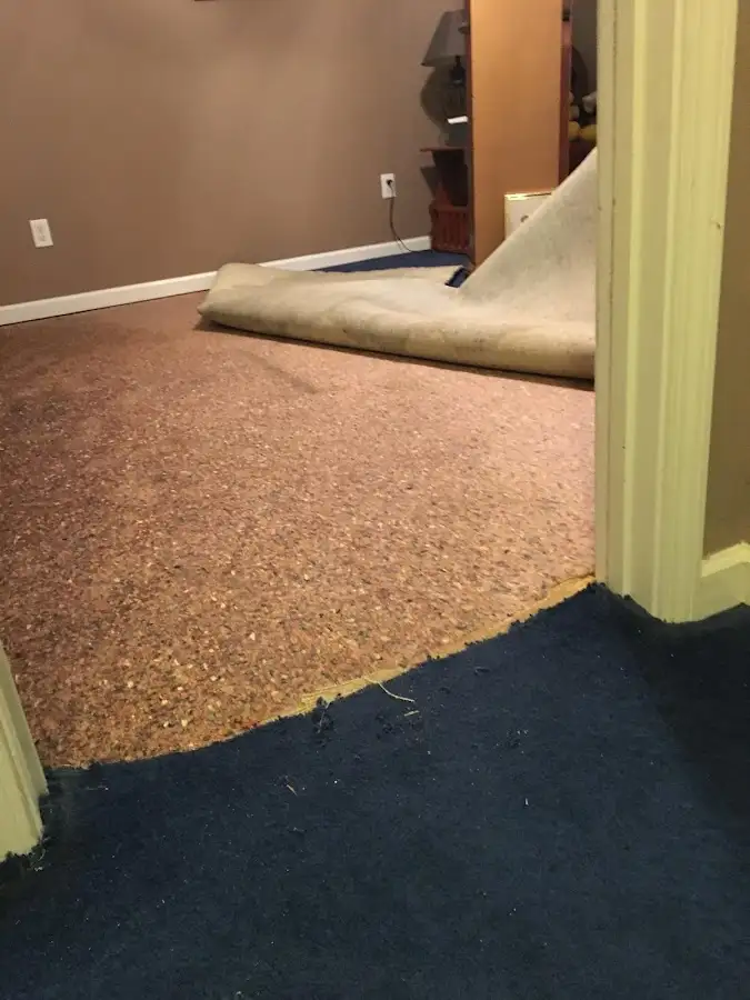 Carpet pad removal revealing water damage during Water Mitigation Services in Prosser